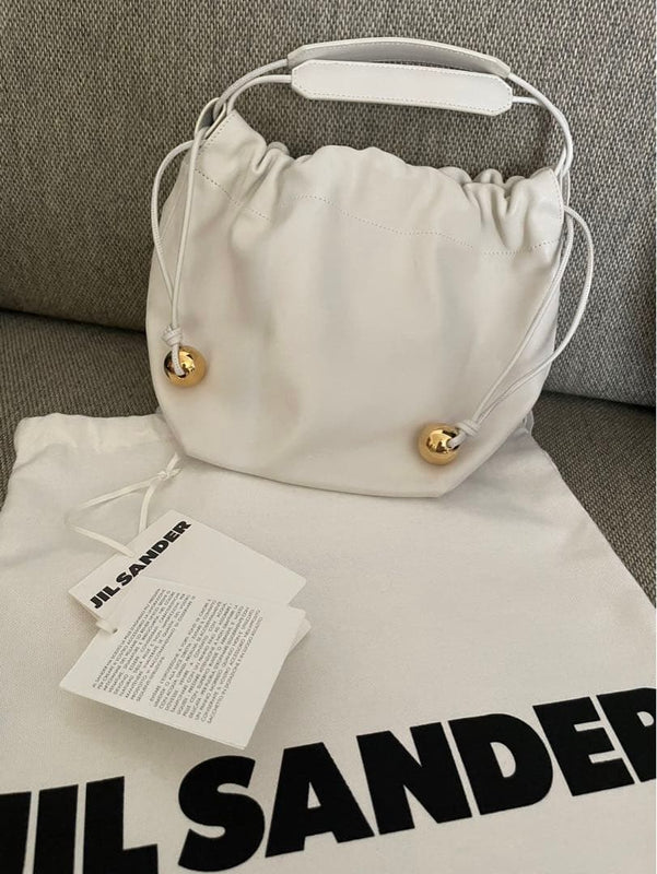 Jil Sander Cannolo Shoulder Drawstring Bag White Leather Gold Pom-pom