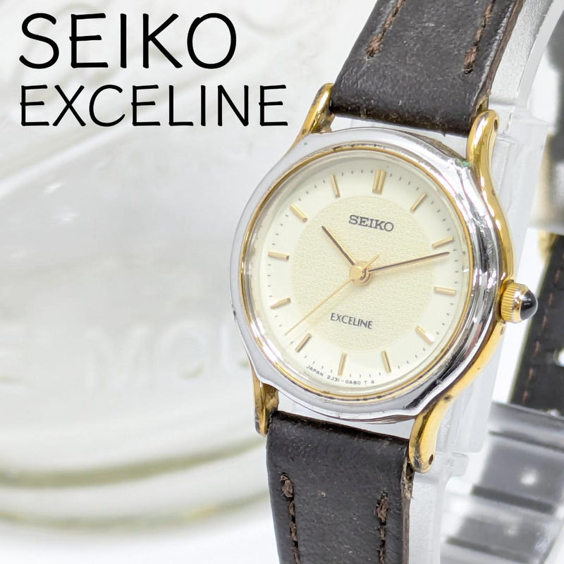 SEIKO EXCELINE Ladies Quartz Watch 28x23mm Silver Gold Tone Case Gold Dial Dark